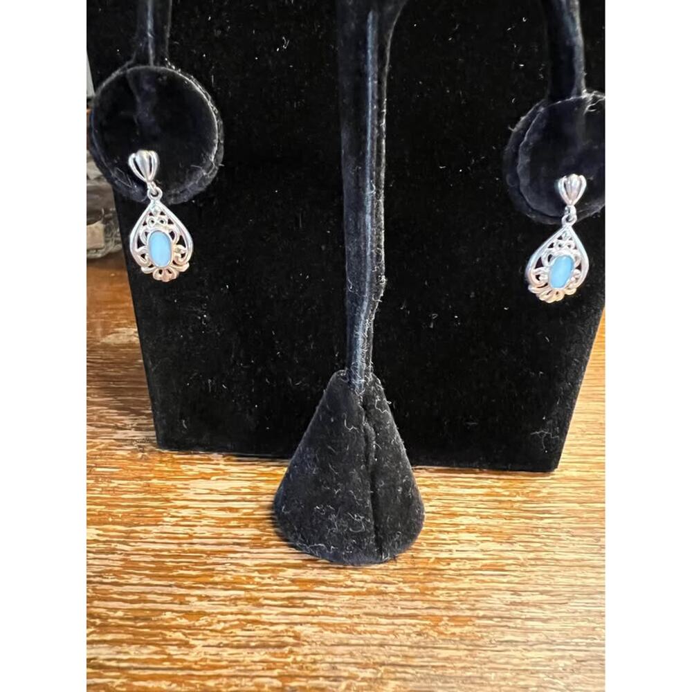 Elegant three-quarter inch, sterling silver and blue glass earrings .925